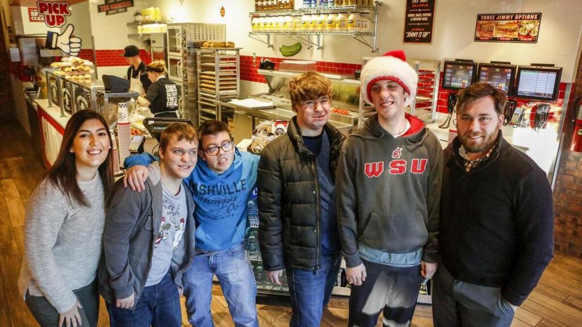 Alex Blanchard, left, and Andrew Pickard, right, with Trillium Employment Services, stand for a portrait with students, from left, Silas Barnett, Tyler Caswell, Riley Gibson and Jack O’Brien, at Jimmy Johns in Gig Harbor. Jimmy Johns works with Trillium to employ students with disabilities after they leave school. Trillium has partnered with the Peninsula School District.