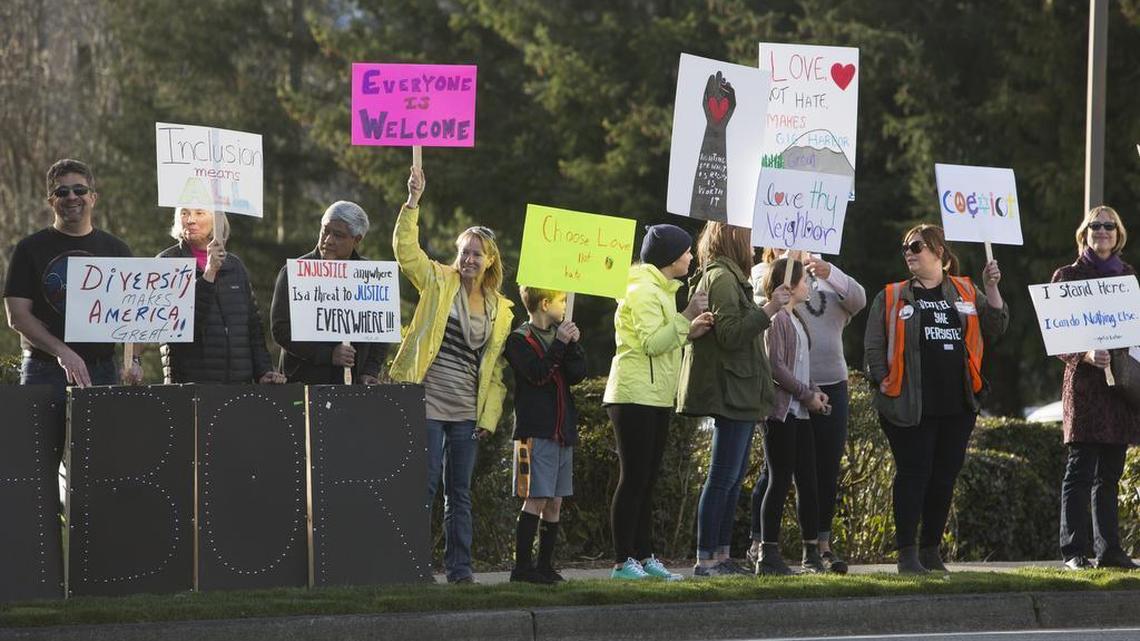 People line Point Fosdick Drive Northwest during a protest put on by Indivisible Gig Harbor and Indivisible Tacoma in Gig Harbor on Friday. People showed up to protest a Tacoma Narrows Tea Party event hosting Heidi Mund in a conference room at the Gig Harbor Library. However, the event didn’t appear to happen as planned as the doors to the library were locked at the start time of the event, leaving several would-be-attendees out.