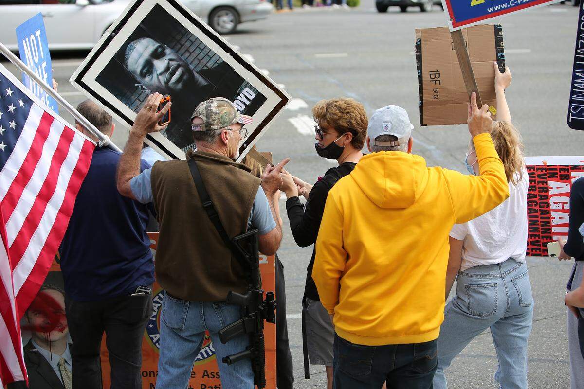 John Skansi (right) standing next to a man with a gun at a Gig Harbor protest for Black Lives Matter last year. Photo by Ronnie Glover.