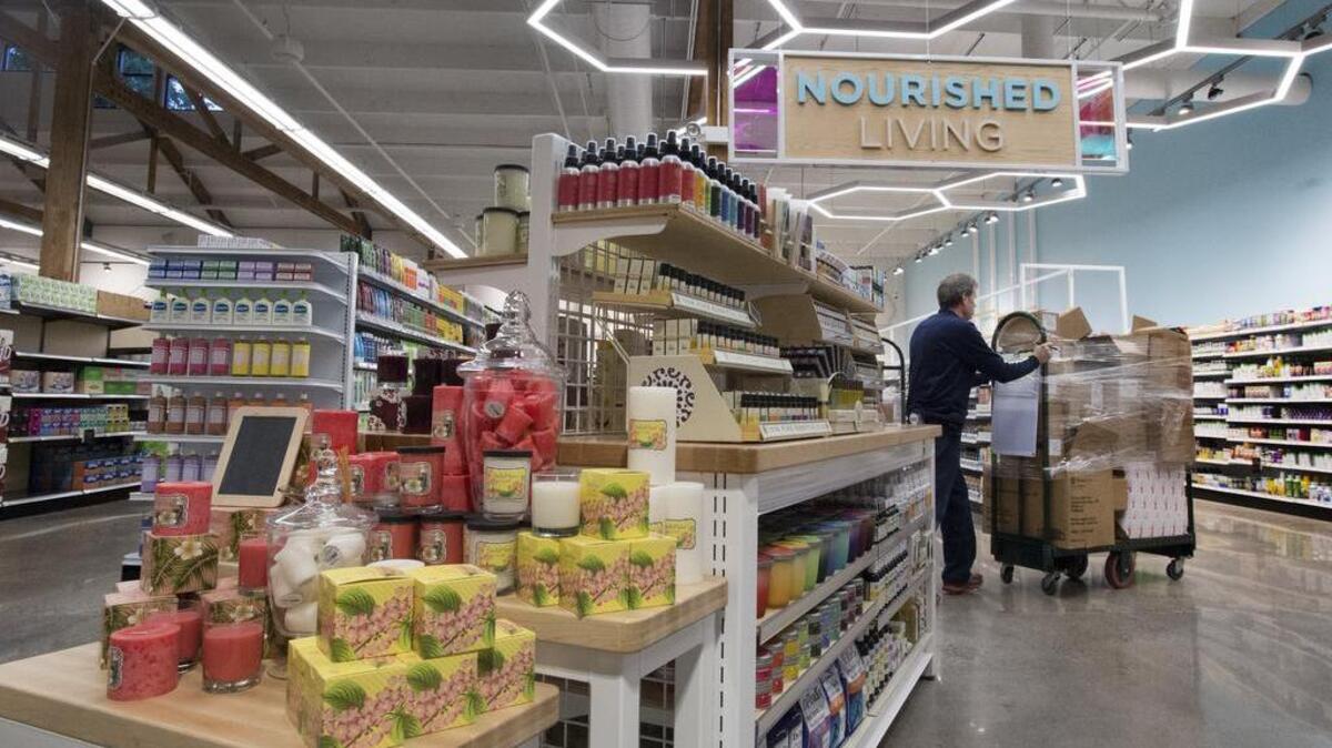 A display of fresh-scented candles fronts the entrance to “Nourished Living,” the health and beauty department of Main & Vine.