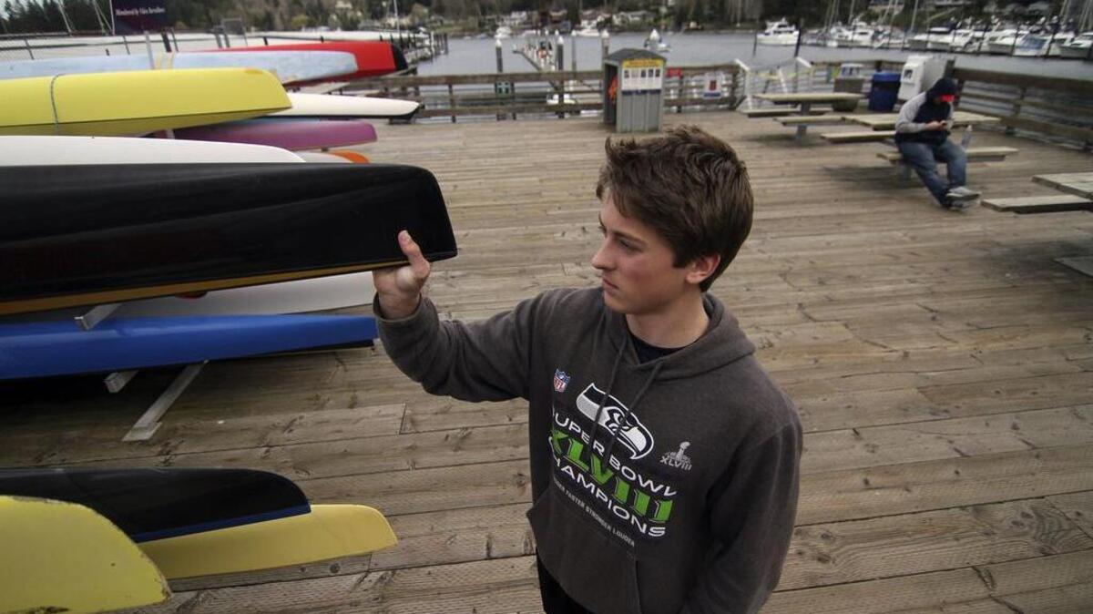 Jack Capper, a Gig Harbor High School sophomore and three-year member of the Gig Harbor Canoe and Kayak Team, gets ready to remove a boat for practice last week.