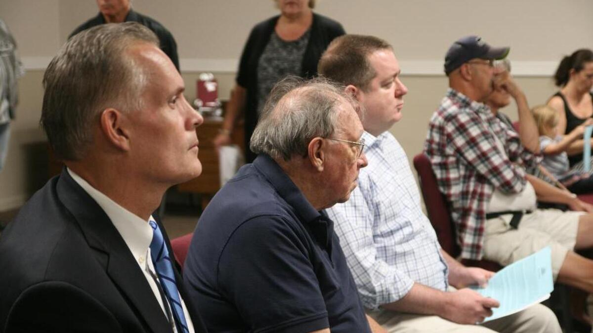 From left, Pierce County Prosecuting Attorney Mark Lindquist, former state Rep. Larry Seaquist, and Pierce County Council member Derek Young await their turns to address the gathering at Friday’s Hope Recovery Center forum in Port Orchard.