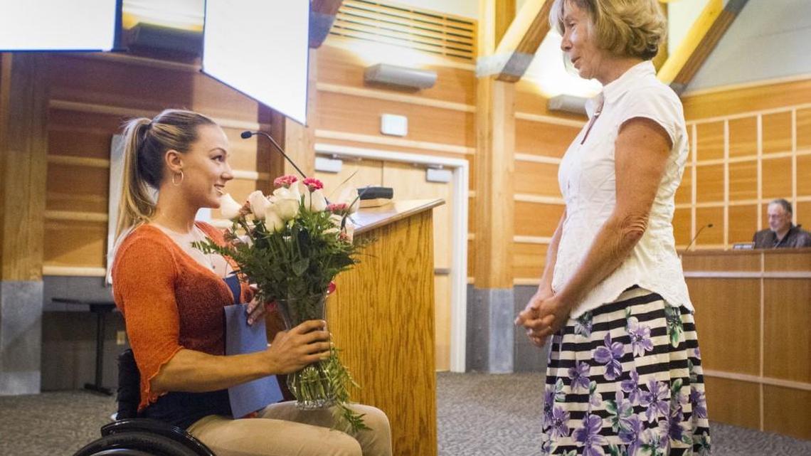 Megan Blunk, left, talks with Gig Harbor Mayor Jill Guernsey during a recognition for Blunk at the Gig Harbor City Council meeting at City Hall on Monday.