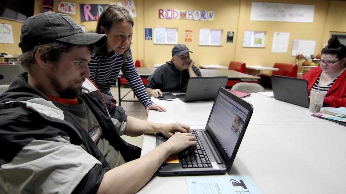 Educator Leigh Sutherland helps works with student Rigel Greenway as Marcelo Lara and Hannah Epperly work Monday at the Red Barn Youth Center on the Key Peninsula.