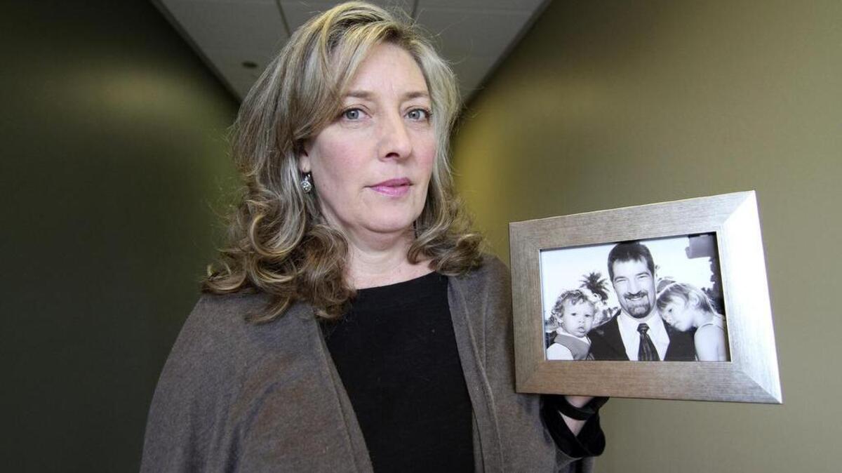 Lise Tanner holds a photo of Rick Johnson and his children. Tanner is a Gig Harbor resident whose niece and nephew are being detained in New Zealand. Tanner has started on organization called Children at Borders to bring awareness to these type of situations.