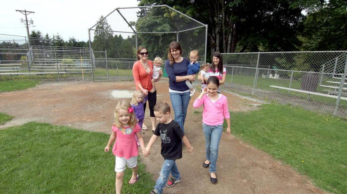 Gig Harbor moms and their children take a leisurely stroll along the baseball diamond at Crescent Creek Park. The two-year 2017-2018 work plan for Gig Harbor’s Parks Commission was approved by the City Council at Monday’s meeting. Six capital projects and planning items have been identified on the work plan, which includes a master plan for Crescent Creek Park.