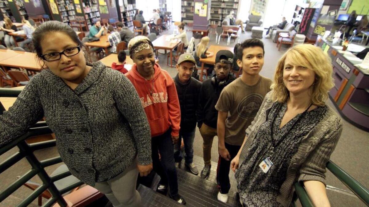 World Language students Hermelina Victriano, Sarina Blanco, Exael Martinez, Ronel Blanco, Kantapong Patcharanu, from left, stand with their teacher, Erika Arnett, at Peninsula High .