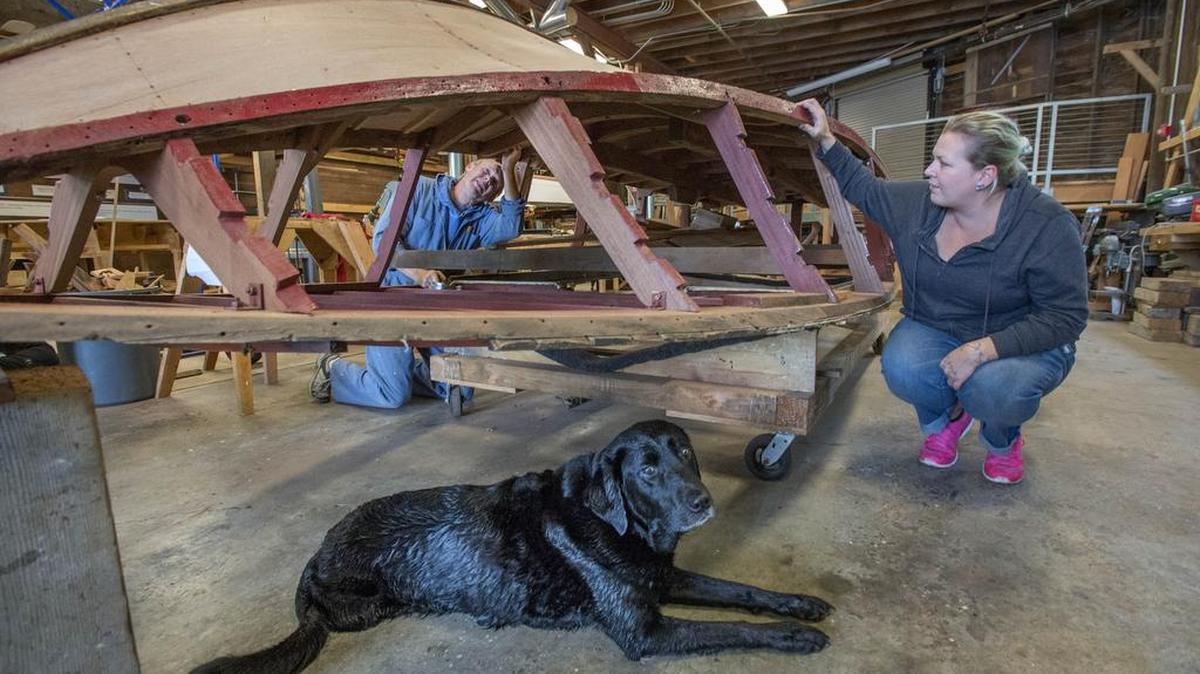 Bruce Bronson, left, works on restoring a 1964 mahogany runabout at the Gig Harbor BoatShop located at historic Eddon Boatyard. Following his lead is Liz Wren-Staples, a UWT student.