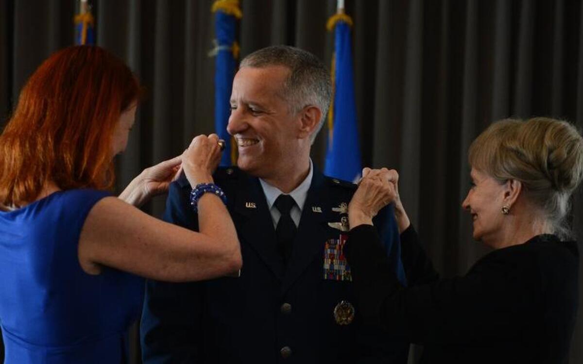 
U.S. Air Force Maj. Gen. Vincent Mancuso, a Gig Harbor native, has his new stars pinned on by his wife, Dr. Sherry Chappell, left, and his mother, Rose, during a promotion ceremony Sunday at the Museum of Flight in Seattle. 
