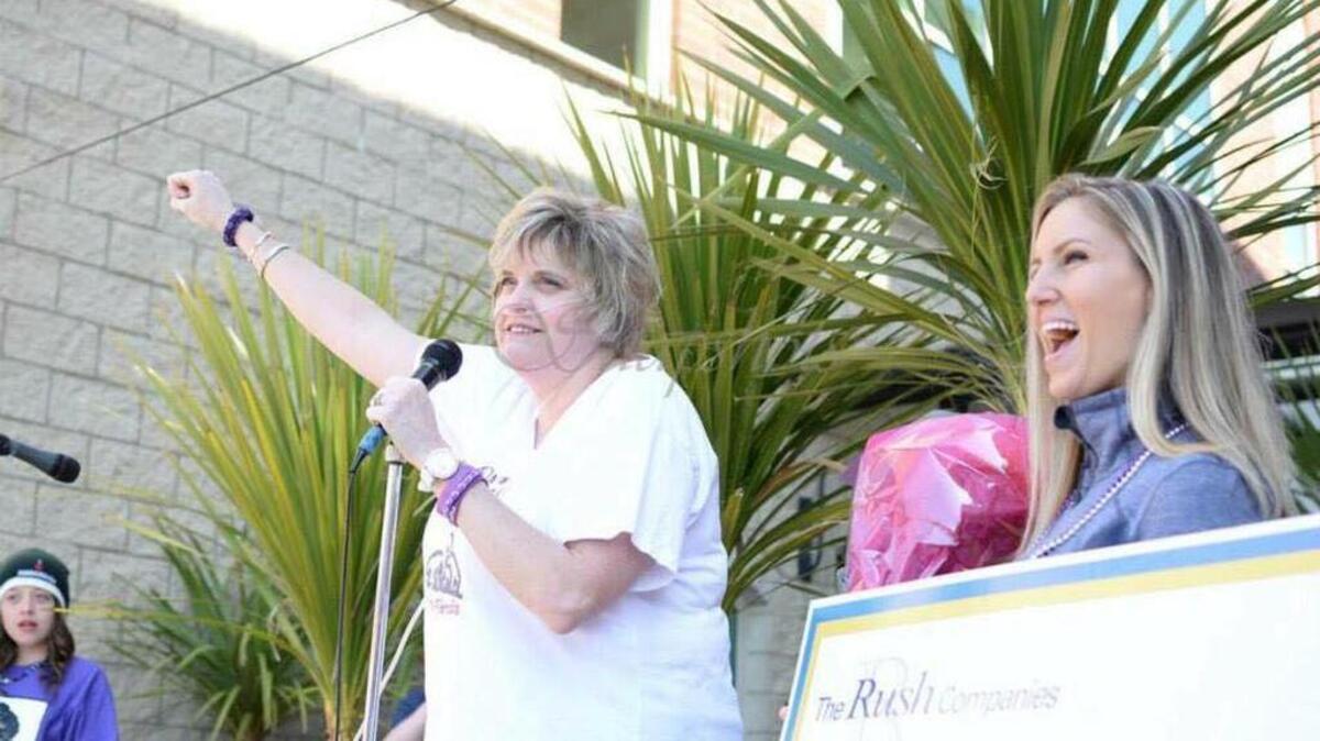 Gig Harbor resident Jenny Adams, 48, greets crowds at the 2015 Great Strides Walk to raise money for cystic fibrosis research. Adams, a cystic fibrosis patient, received a double-lung transplant on April 22.