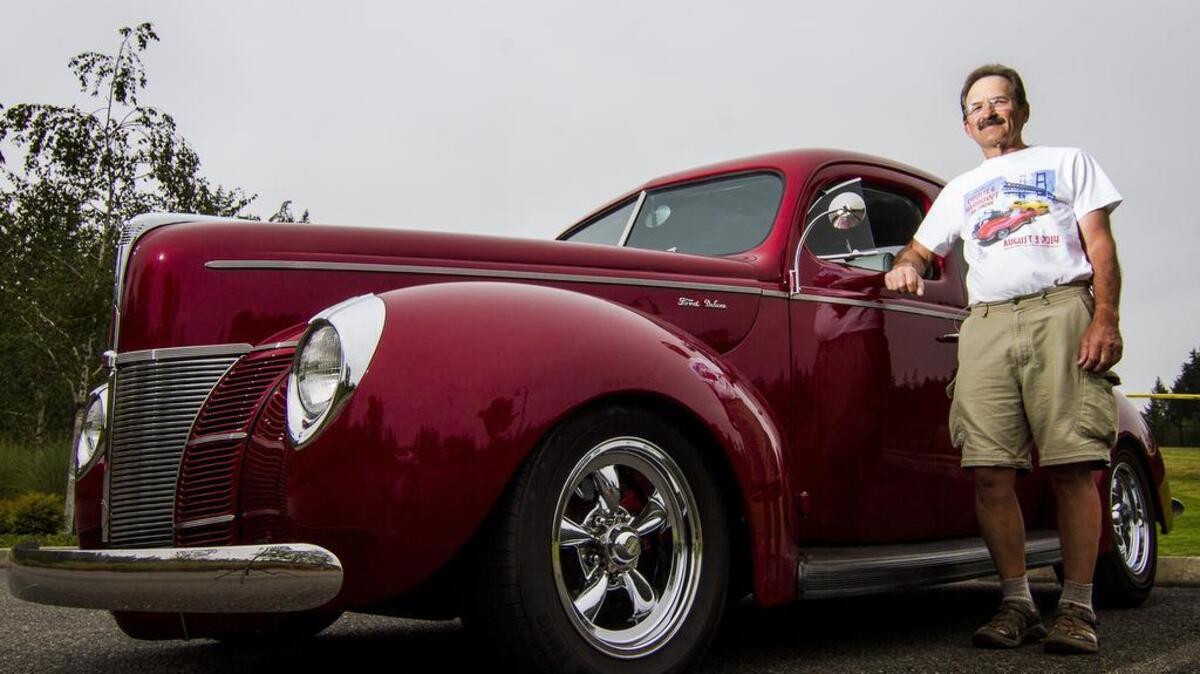 Bob McCord, secretary of Gig Harbor Cruisers, stands next to his 1940 Ford Deluxe Coupe in Gig Harbor.