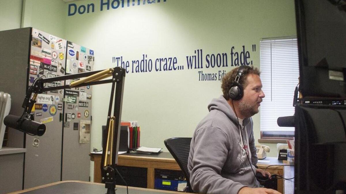 Former station manager Spencer Abersold works the booth at the KGHB radio station at Peninsula High School in Purdy.