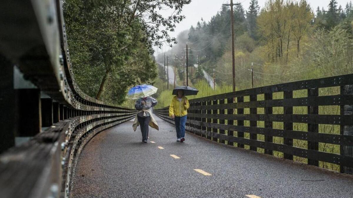 Friends Gwen Daubs, left, and Lois Lerum of Gig Harbor enjoy some talk while they walk the Cushman Trail. The phase three work done on the trail recently won the America Public Works Association’s Washington chapter’s Project of the Year Award. Daubs and Lerum raved about the trail and how much they enjoyed the natural beauty they saw as they strolled the path, which is made out of environmentally friendly pervious asphalt . The third phase of the trail was built from 96th Street to Burnham Drive and features a 1,300-foot-long pin-pile trestle bridge that was designed to minimized impacts on the wetland below.