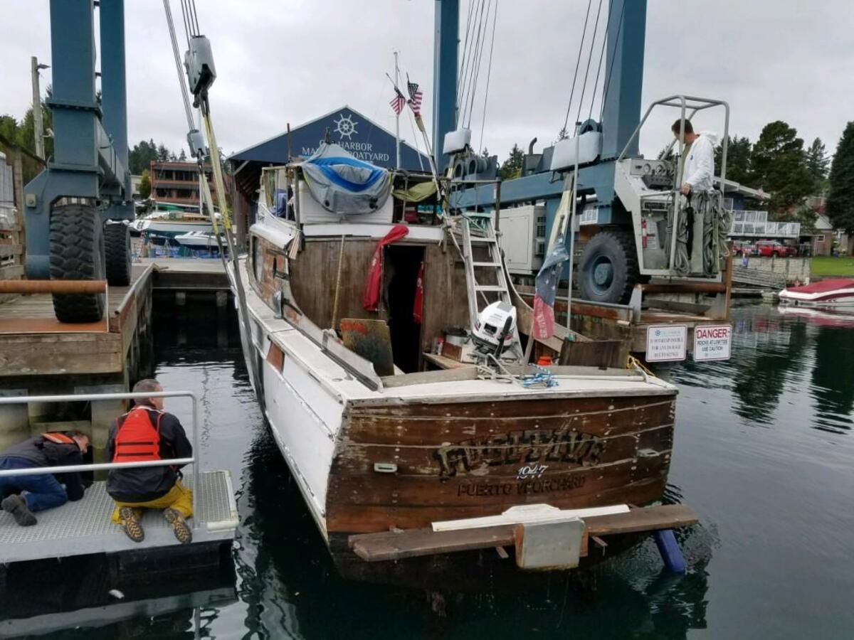 A boat named “The Fugitive” was pulled out of the water by Gig Harbor police after nearly sinking at the Gig Harbor Marina.