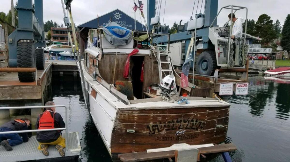 A boat named “The Fugitive” was pulled out of the water by Gig Harbor police after nearly sinking at the Gig Harbor Marina.
