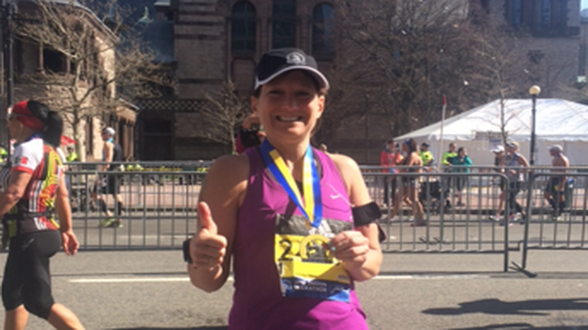 Maryanne Tomich, 50, stops for a photo after completing the 2016 Boston Marathon on April 18. This was her fifth Boston Marathon.