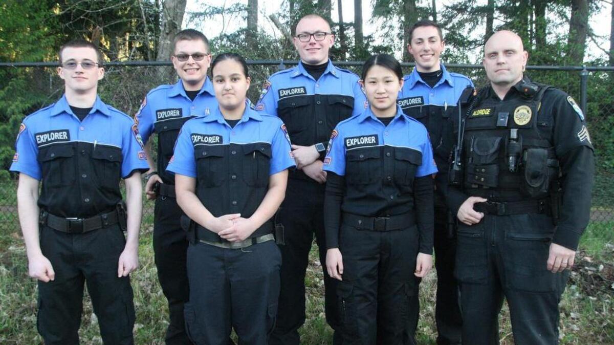 Gig Harbor Police Department Sgt. Darius Aldridge, right, advisor for the department’s Explorer Police Program, joins Explorers, from left, Gig Harbor High senior Andrew Vaniderstine, GHHS junior Parker Lucey, GHHS freshman Ivy Stout, Tacoma Science and Math Institute senior Kirk Foreman, GHHS junior Sara Sharp and Peninsula High junior Josh Nichols at a training session Monday.