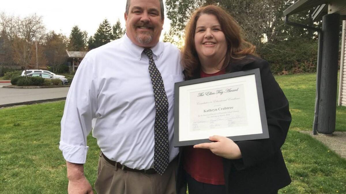 Katie Crabtree, Peninsula High School teacher and Ellen Fay award recipient, poses with Principal Dave Goodwin outside the district office on March 24 after receiving her award at the school board meeting.