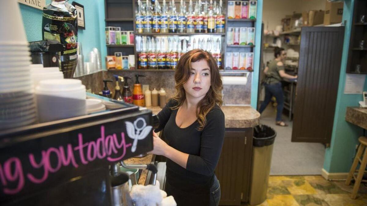Maddy Dullum makes a drink May 25 while Emily Davis prepares food in the kitchen at Kimball Espresso Cafe in Gig Harbor.