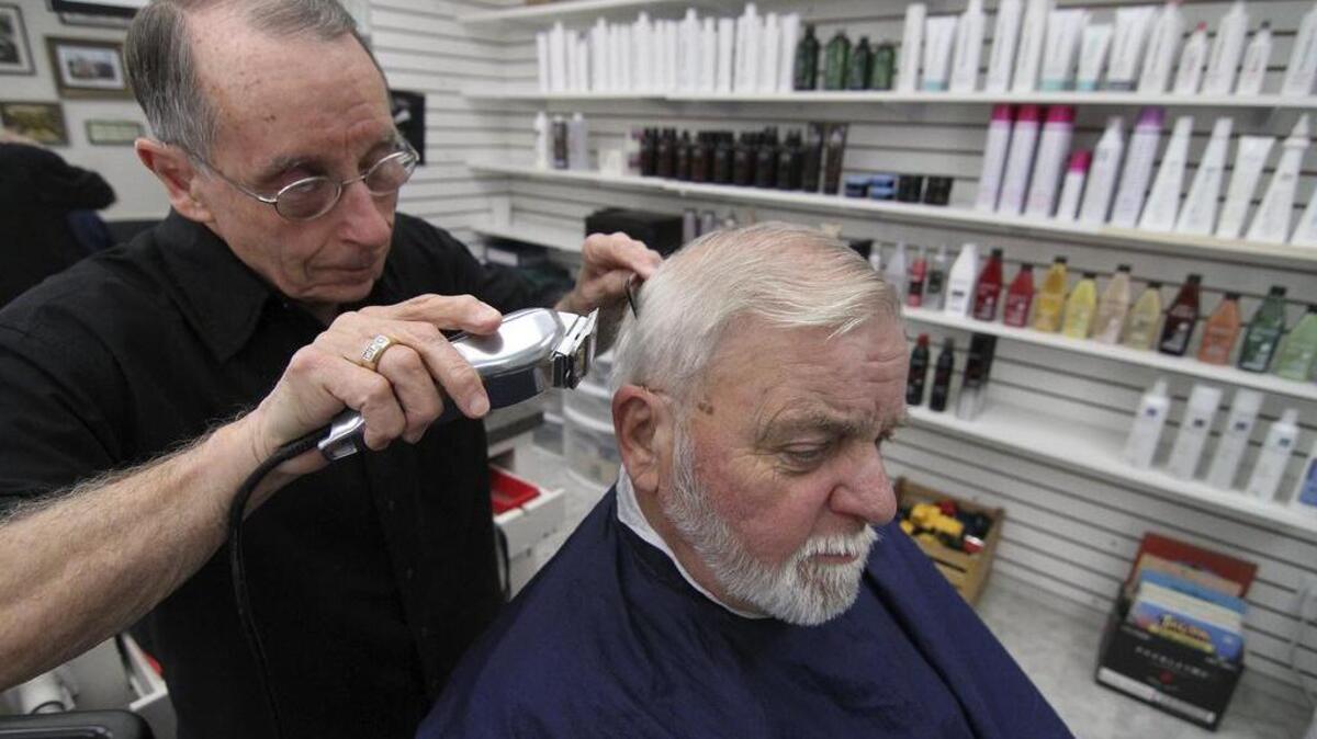 
Jim Lince trims customer Wynn Smith’s hair last week. On Wednesday (Sept. 30), Lince will retire from a long career as a barber.
