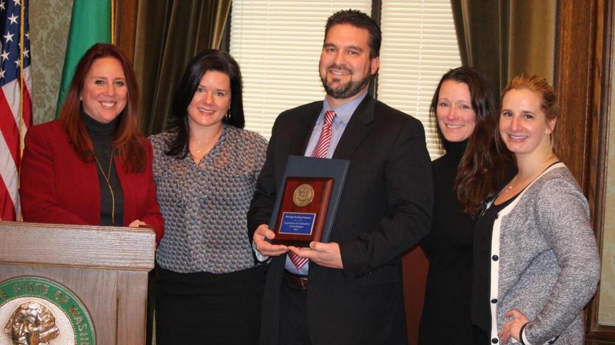 Heritage Distilling was one of four Washington companies to be awarded the 2015 Corporations for Communities Award from Secretary of State Kim Wyman on Dec. 16. Wyman, left, presents a National Association of Secretaries of State Medallion Award to Jennifer Stiefel, president of Heritage Distilling Company; Justin Stiefel, CEO/master distiller; Julie Dugan, executive director of the Dugan Foundation, and Hannah Hanley, director of marketing for Heritage.