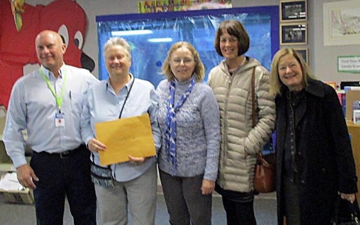 Staff at Evergreen Elementary School received a $3,000 literacy grant from the Gig Harbor Garden Tour Association on Nov. 18. Evergreen Principal Hugh Maxwell, left, Garden Tour Association President Jan Reeder, Evergreen Elementary office manager Betty McCord and Garden Tour Grant Selection Committee members Marion Ekberg and Lori Bonvincini pose for a photograph.
