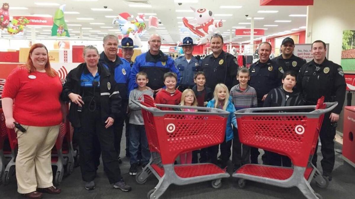 Holiday Heroes from the Gig Harbor Police Department and Washington State Patrol pose with the children they took shopping and Target staff at the Gig Harbor Target on Dec. 8.