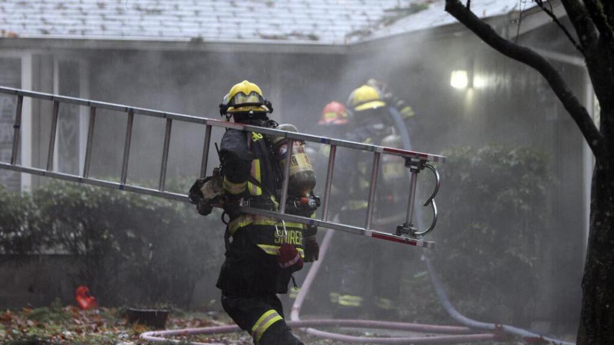 Firefighters rush to stop a house fire Tuesday afternoon in Gig Harbor. The blaze was possibly started when an unattended candle started a fire in a young girl’s bedroom. A mother and child safely evacuated the residence, located in the 7900 block of 54th Ave. NW in Gig Harbor, just before firefighters arrived and knocked down the blaze.