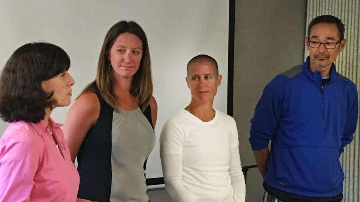 Kopachuck Middle School Principal Heidi Fedore, left, presents teachers Alexa Shanafelt, Carol Clingan and Dave Miyake with the Mary Lee Squires Award during the Peninsula School Board meeting May 12. Team member Steve Gernon is not pictured.