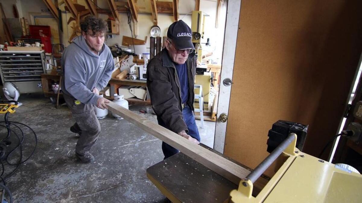 Doyle Lewellen and his father, Jerrell, run fresh cut White Oak through a machine Friday afternoon at the Harbor History Museum.