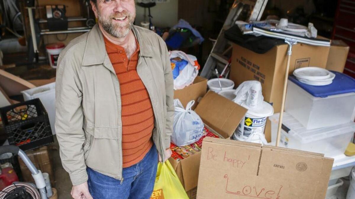 David Cathers stands with some of the donated food collected during a recent Make A Difference Day event. The food will be used to put together baskets to donate to families for Thanksgiving. Each basket the brigade puts together includes a turkey and pan, along with a box with about a weeks worth of food that includes everything from mashed potatoes to rice, pasta and peanut butter.
