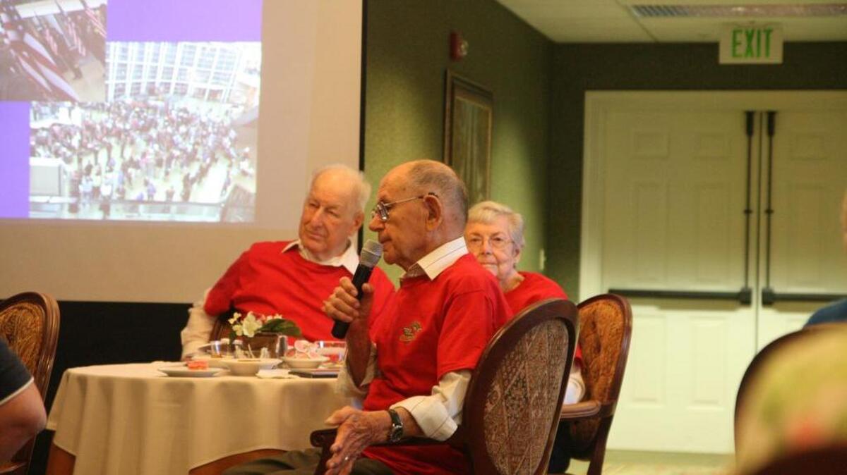 Puget Sound Honor Flight attendees John Yacko, Melvin Franz and Ailene Tronca, from left, speak to the crowd at a luncheon in their honor Tuesday at Harbor Place in Gig Harbor. The three returned late Monday night from a trip to Washington D.C.