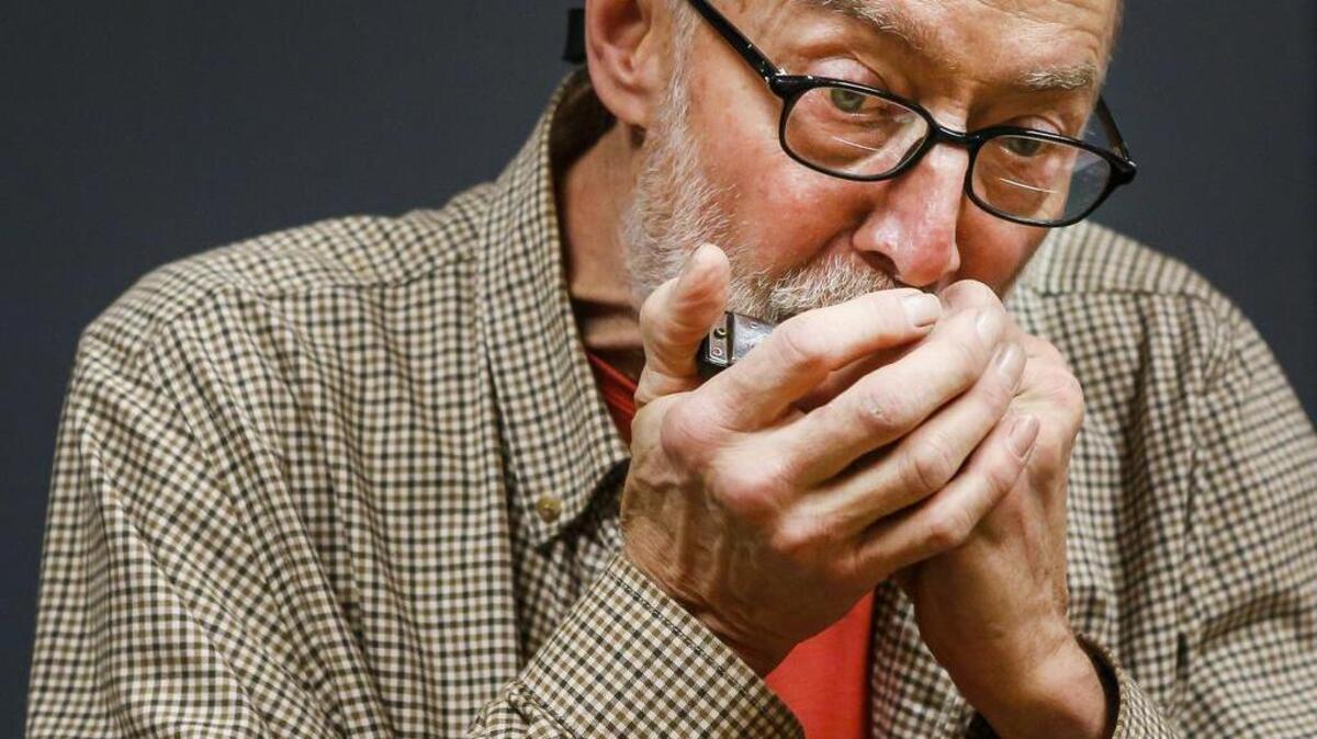 Forest Lane, pictured here earlier this year playing at the YMCA, played his harmonica for the Gig Harbor City Council on Monday. Lane says playing the harmonica helps him keep his lung capacity up and helps fight the effects of Parkinson’s disease.