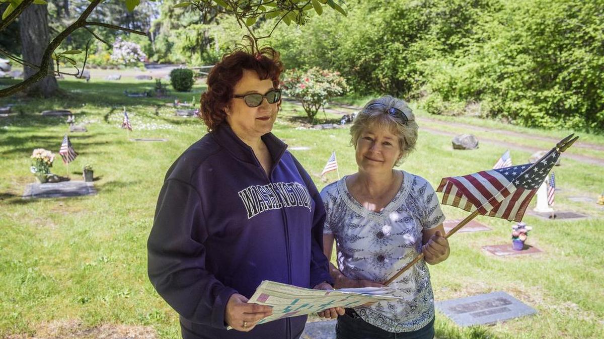 Volunteer Merrillee Royse, left, and Judy Hackett-Wilson, president of the Fox Island Cemetery Association, stand at the Fox Island Cemetery. The association will host its annual Memorial Day event on Monday (May 29) honoring veterans buried there dating back to the Civil War.