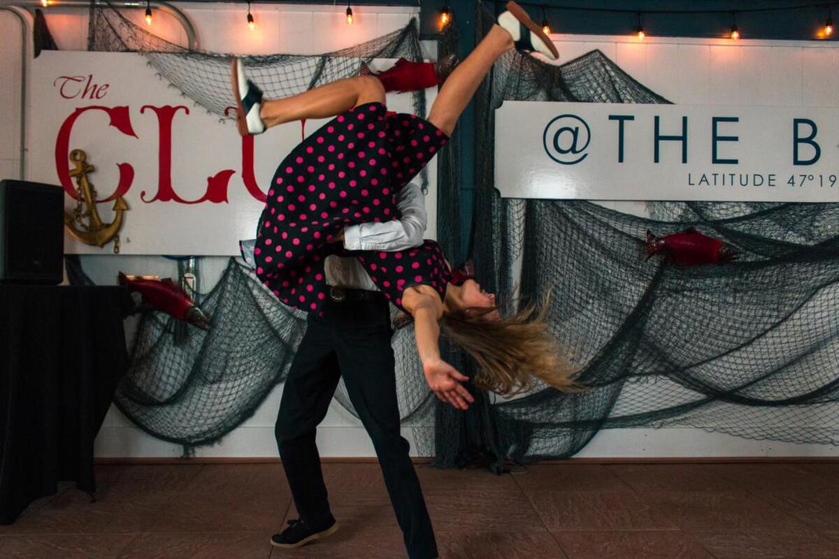 Tucker and Harley Ewell demonstrate a swing dance move.