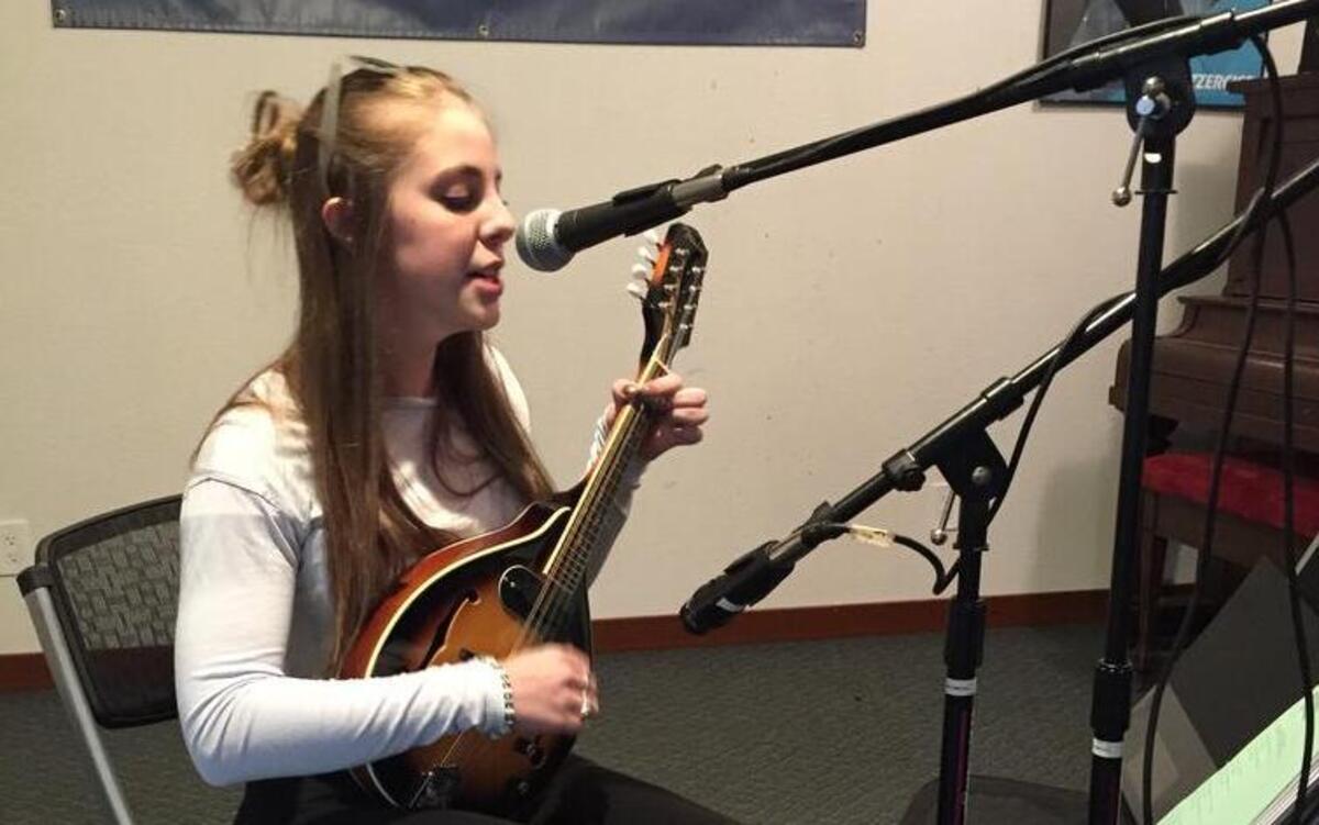 Sophia Folz, 13, plays her mandolin as she sings during an open mic test run at Rosedale Hall on March 30. The first teen open mic will be held at the Hall on April 29.