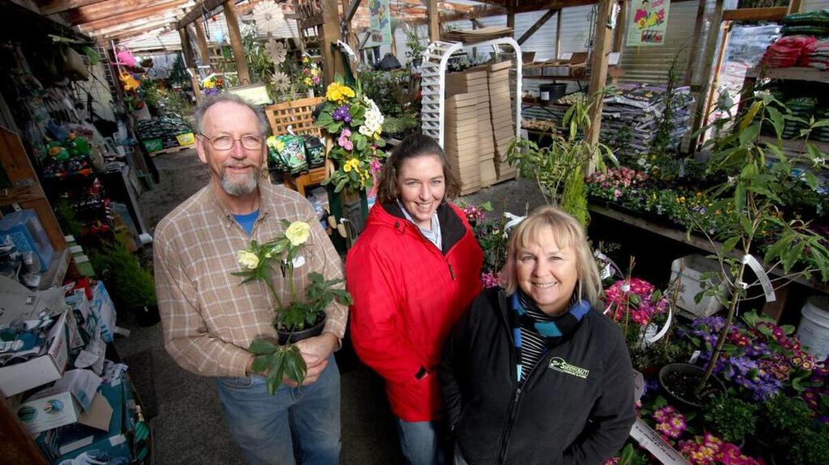Dale and Claudia Loy, pictured in 2013 with their daughter Amy Shaver, center, have been serving their Key Peninsula customers at their business, Sunnycrest Nursery and Floral, for 35 years. They are now looking to sell the business and retire.