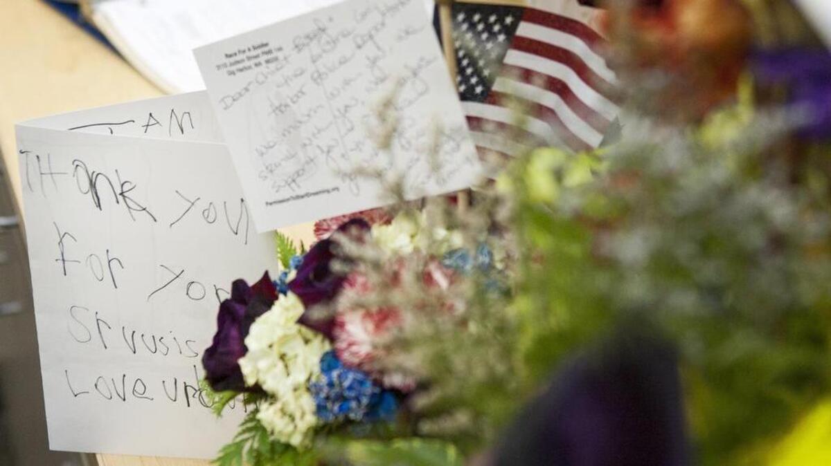 Flowers and cards showing support from community members of all ages are shown at the Gig Harbor Police Department.
