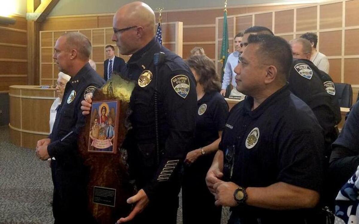 Gig Harbor Police Chief Kelly Busey, left, Lt. Fred Douglas and Detective Mike Cabacungan accept a plaque at the City Council meeting Monday night.