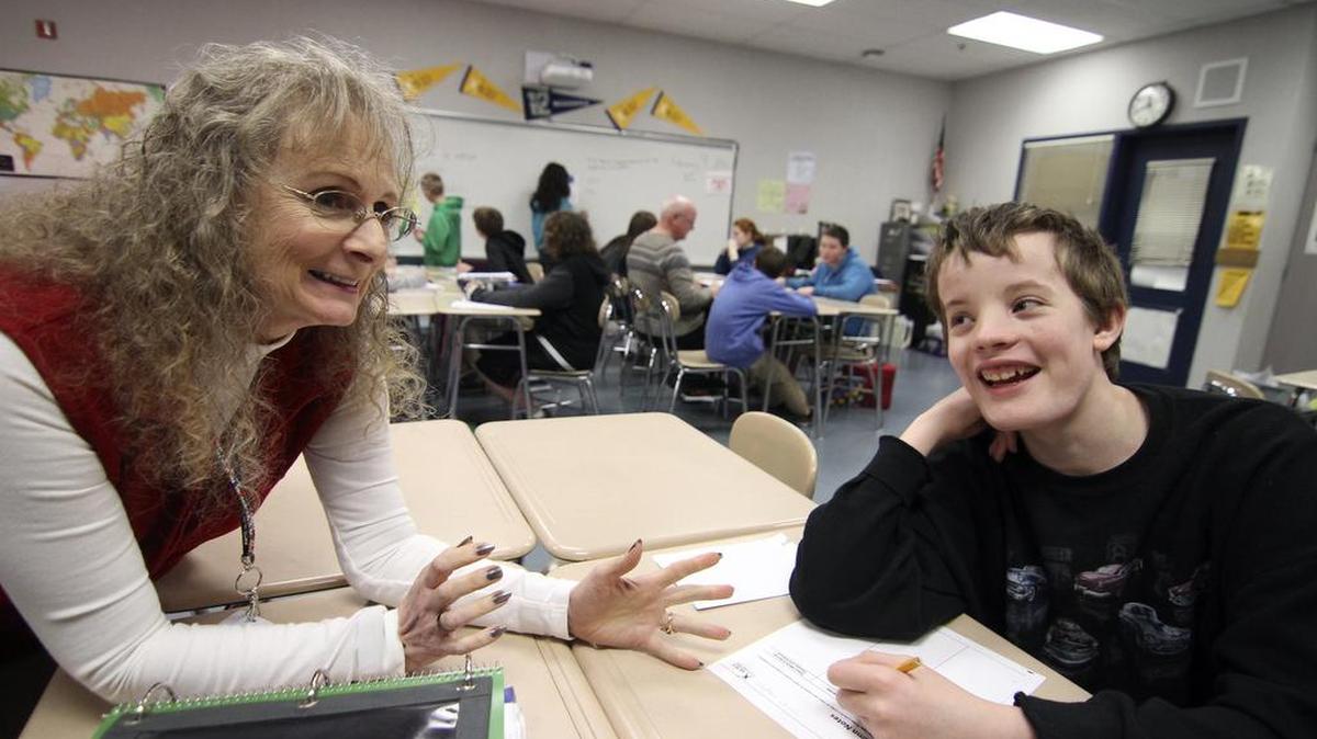 Key Peninsula Middle School teacher Janet Eidsmoe works with AVID student Curtis Staples in her classroom last week.