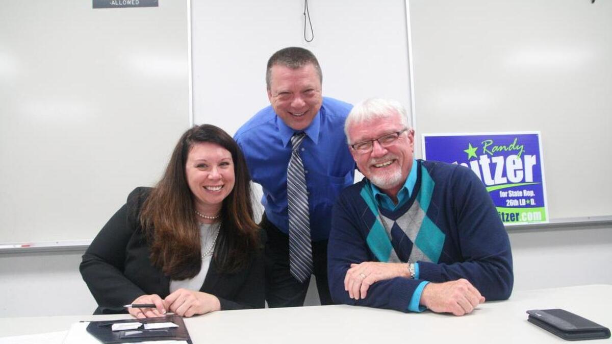 At the close of their Sept. 19 debate at the Key Peninsula Democrats Club, state Rep. Michelle Caldier (R) and her challenger, Randy Spitzer (D), flank program moderator John Kelly.