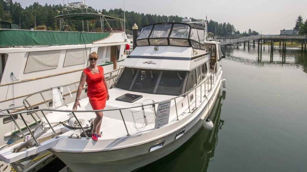 Danielle Taylor, hospitality manager for Gig Harbor Marina & Boatyard, shows “Suite Dreams,” a boat that can be used at dock as a vacation rental, part of the marina’s new Fleet Suites program.