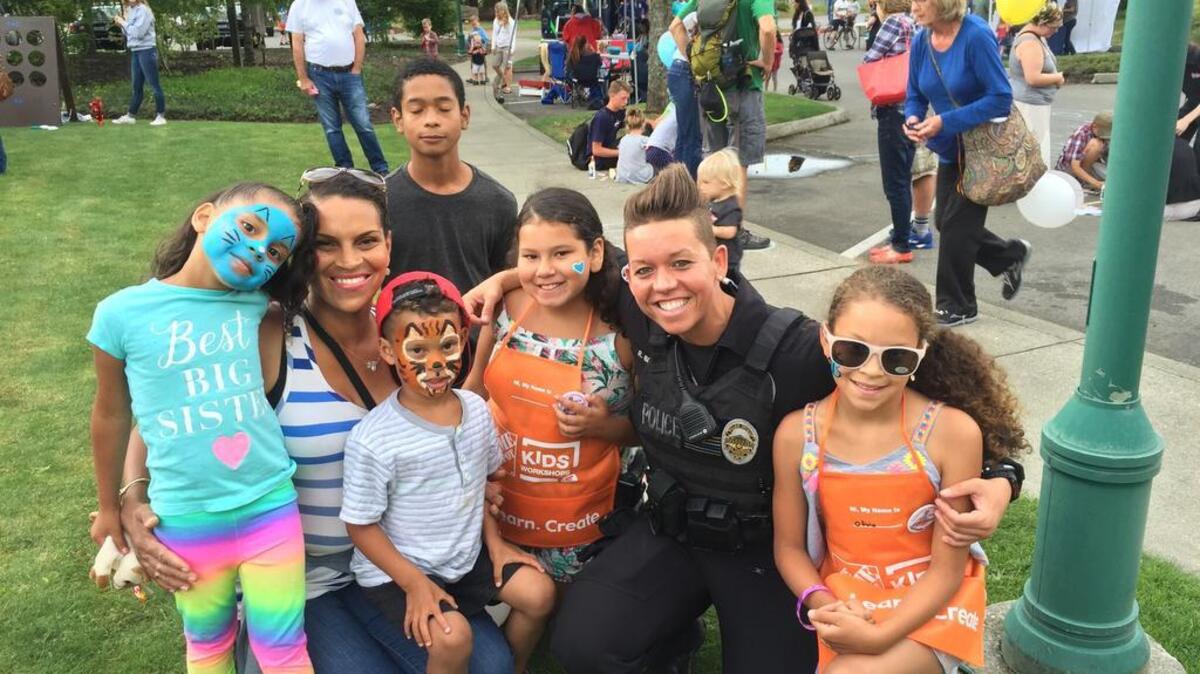 Former Gig Harbor police officer Raquel “Rocky” Brunson poses with children and parents during the 2016 National Night Out.