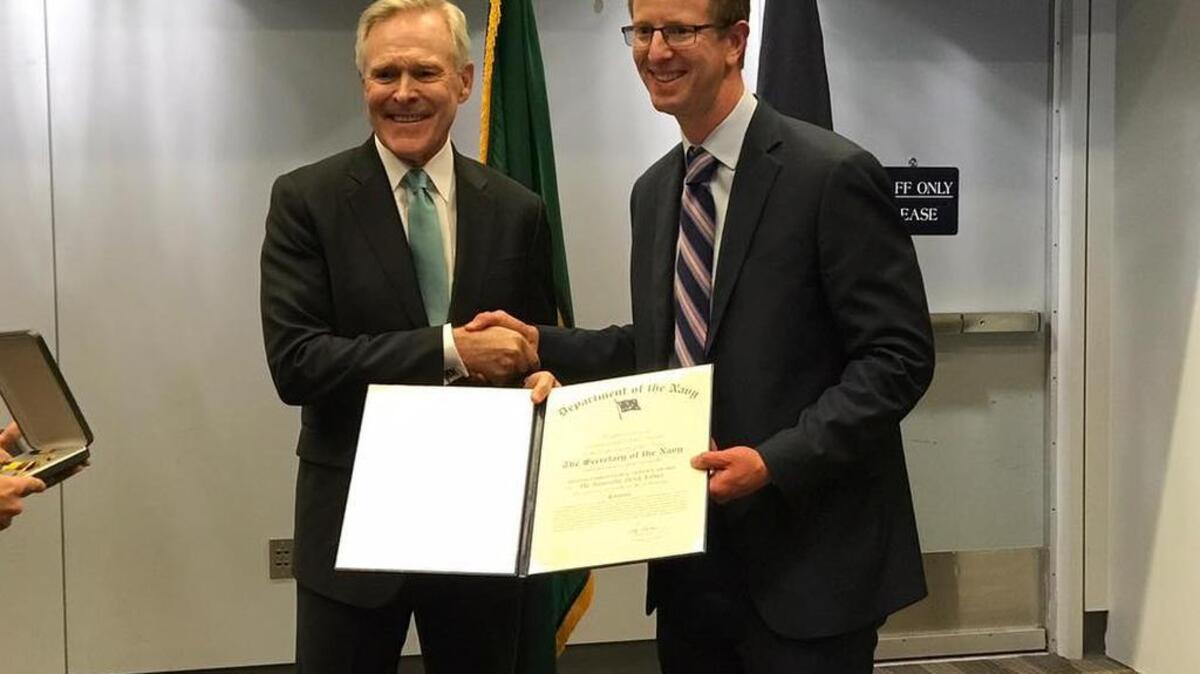 U.S. Rep. Derek Kilmer (D-WA) receives the U.S. Navy’s Distinguished Public Service Award from the Secretary of the Navy Ray Maybus during an address to local leaders and military personnel Friday in Bremerton.