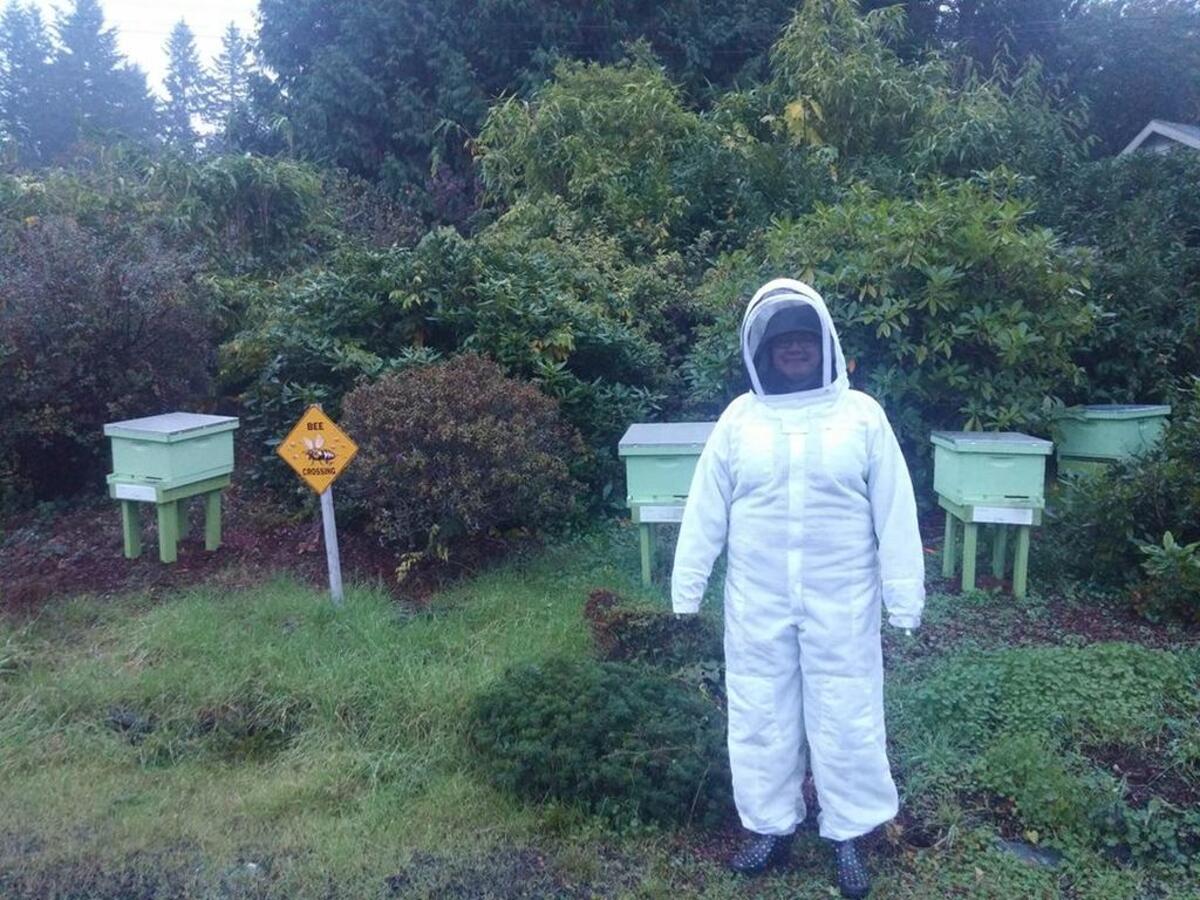 Peninsula Gateway reporter Andrea Haffly poses in a bee suit, facing her fears while writing one of her first-ever Gateway centerpiece’s about Bee Maven, a Gig Harbor hive adoption service run by Jonathan Tuite.