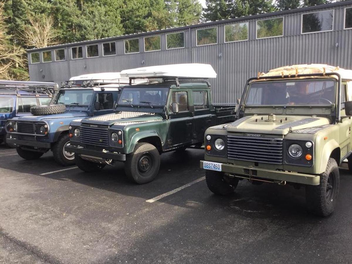 A trio of Land Rover Defenders parked outside Brian and Michele Hall’s Defenders Northwest shop in Gig Harbor.