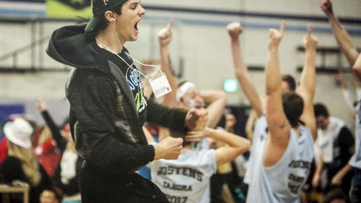 Jack Filkins, a student at Peninsula High School, lets out a cheer after guessing correctly during a mass game of heads or tails at the Jostens Leadership Conference at Gig Harbor High School.