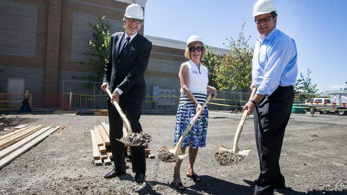 Frank Rimkus, CEO of Galaxy Theaters, left, Gig Harbor Mayor Jill Guernsey and John Hogan, managing partner of Uptown, stand for a portrait with gold shovels during a July 20 groundbreaking ceremony for the new IMAX theater.