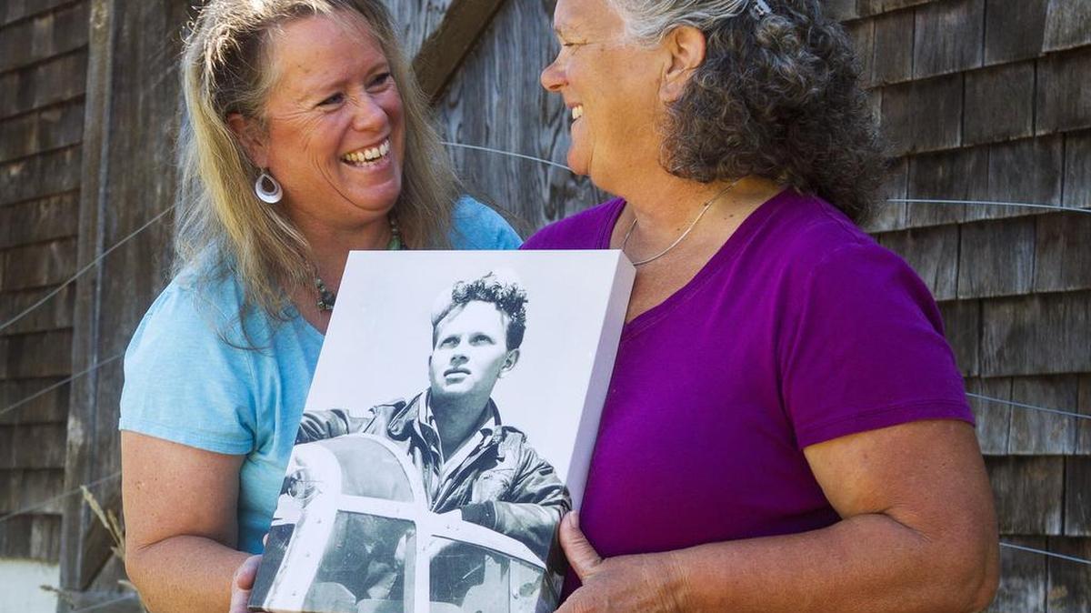 Stephanie Lile, left, and her sister Kathy Hall found a stash of World War II photographs and a mission diary left by their father when cleaning out a barn on their property. The photographs and documents inspired Lile to write a young adult novel based around World War II and open the Bomber Boys traveling exhibit.