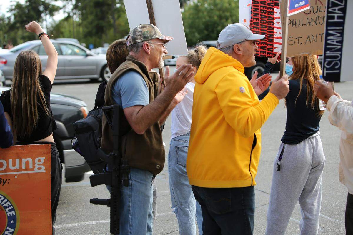 John Skansi (right) marching next to a man with a gun at a Gig Harbor protest for Black Lives Matter last year. Photo by Ronnie Glover.